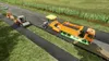 Construction vehicles are paving a road in a rural setting. Produktbild-Vorschau