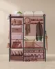 A multi-shelf storage unit with various items organized on its shelves and hooks. Náhled obrázku produktu
