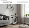 A living room scene featuring a sofa, a side table, and plants. Produktbild-Vorschau