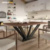 A dining table with a V-frame base in a modern kitchen/dining room setting. Voir les images du produit