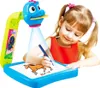 A young girl is using a drawing projector toy to trace a horse onto a piece of paper. Náhled obrázku produktu