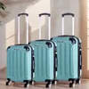 Three teal suitcases of varying sizes are lined up against a light-colored wall. Náhľad obrázku produktu