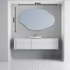 A modern bathroom vanity with a sink and an irregular-shaped mirror mounted above it. Produktbild-Vorschau