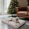A dog lying on a dog bed in front of a Christmas tree and a leather couch. Anteprima dell’immagine prodotto