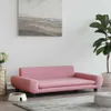 A pink dog bed is placed on a rug in a room with a plant and a painting on the wall. Náhľad obrázku produktu