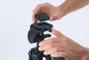 Hands attaching a camera quick release plate to a tripod head. Anteprima dell’immagine prodotto