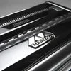 Close-up of a metallic pasta maker with its brand logo. Anteprima dell’immagine prodotto