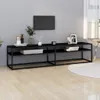 A black TV stand with a TV mounted on the wall above it, in a room with light gray walls and wooden flooring. Podgląd zdjęcia produktu