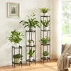 A collection of plant stands with plants in a well-lit room. Voir les images du produit