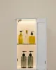 A white bathroom cabinet with internal lighting displaying various bottles of soap or lotion. Náhled obrázku produktu