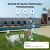 A girl and a dog are playing in a backyard with a swimming pool in the background. The image highlights smart detection features of a security camera. Produktbild-Vorschau