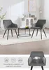 Two dark gray upholstered chairs with black metal legs are placed in a living room setting, with a coffee table between them. A smaller inset image shows a close-up of one chair with feature icons and text. Produktbild-Vorschau