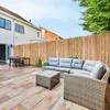 A backyard patio with outdoor furniture and a wooden fence. Produktbild-Vorschau