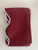 A folded piece of fabric with a decorative edge. Produktbild-Vorschau
