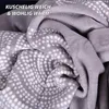 A close-up view of a soft, patterned blanket. Produktbild-Vorschau