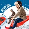 Two children sledding down a snowy hill on red sleds. Produktbild-Vorschau
