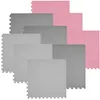 A stack of interlocking foam puzzle mats in gray and pink. Produktbild-Vorschau