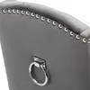 Close-up of the back of a gray upholstered chair, showing decorative studs and a metal ring. Produktbild-Vorschau
