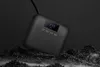 A black portable air compressor rests on a dark, textured surface with some misty elements. Produktbild-Vorschau