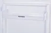 A close-up view of a clear plastic shelf inside a white refrigerator, with the brand name 'TELEFUNKEN' printed on it. Produktbild-Vorschau
