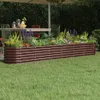 A raised garden bed filled with plants is shown in a backyard setting, with a table and chairs visible in the background. Produktbild-Vorschau