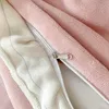 A close-up view of a pink plush fabric with a zipper and white lining. Produktbild-Vorschau
