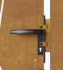 A close-up view of a door handle and lock mechanism on a rusty-looking metal door. Produktbild-Vorschau