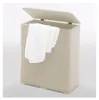 A beige laundry basket with a white towel draped over the edge, shown with the lid open. Náhľad obrázku produktu