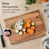 A wooden cutting board with sliced vegetables and onions, next to a knife. There is text overlay on the top left corner. Produktbild-Vorschau