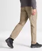 A person wearing khaki cargo pants and black shoes, shown from the waist down, walking against a white background. Produktbild-Vorschau