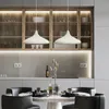 A modern kitchen and dining area with pendant lights over a table set for a meal. Produktbild-Vorschau
