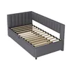 A dark gray upholstered daybed with a wooden slat mattress support is shown from a diagonal angle against a white background. Produktbild-Vorschau