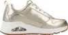 A side view of a gold sneaker on a white background. Voir les images du produit