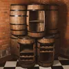 Several wooden barrel-shaped shelves are stacked in a room with a brick wall and a checkered floor. Produktbild-Vorschau