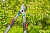 Close-up of two Gardena pruning shears with green foliage in the background. Produktbild-Vorschau