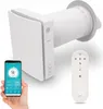 A hand holds a smartphone displaying a smart home app interface, next to a white ventilation unit and its remote control. Náhled obrázku produktu