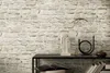 A stone-effect wallpaper is shown behind a console table with decorative items. Produktbild-Vorschau