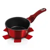 A red metallic saucepan with a black interior and a red handle, placed on a red trivet. Náhled obrázku produktu