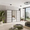 A modern bedroom with a large wardrobe, bed, and seating area. Produktbild-Vorschau