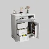 A white bathroom vanity with a sink and faucet, featuring multiple drawers and an open cabinet with toiletries. Podgląd zdjęcia produktu