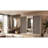 A bedroom scene featuring a large wardrobe with mirrored doors, a dressing table with a round mirror, and a chair. Produktbild-Vorschau