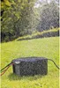 A black box sprinkler system is shown on a grassy lawn, with water spraying from it. Anteprima dell’immagine prodotto