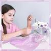 A young girl is sewing with a mini sewing machine. Produktbild-Vorschau