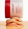 A jar of Medicube Red Succinic Acid Peeling Pad is shown with a stack of pads in front of it. Voir les images du produit