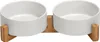 A pair of white ceramic pet bowls on a wooden stand. Produktbild-Vorschau