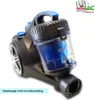 A close-up, angled view of a cyclonic vacuum cleaner with a transparent dustbin and blue filter, set against a white background. A logo and text overlay are present in the upper right and lower left corners. Produktbild-Vorschau