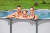 A family is enjoying themselves in an above-ground swimming pool on a sunny day. Produktbild-Vorschau