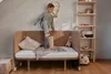 A young boy is playing on a bed with a Jenga tower. Náhľad obrázku produktu