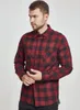 A man wearing a red and black checkered flannel shirt. Produktbild-Vorschau