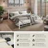 A white metal bed frame with bedding in a bedroom setting, accompanied by marketing text and icons. Produktbild-Vorschau